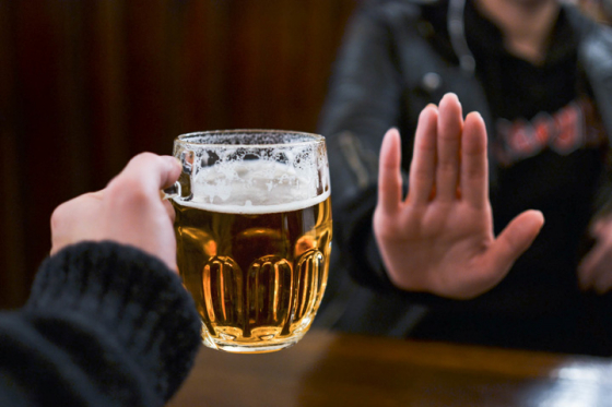 A person refusing a pint of beer while taking part in dry January
